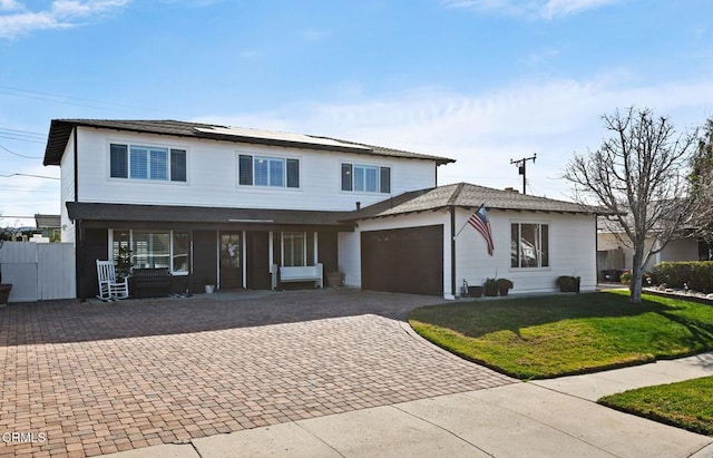 view of front facade featuring a garage, covered porch, and a front lawn