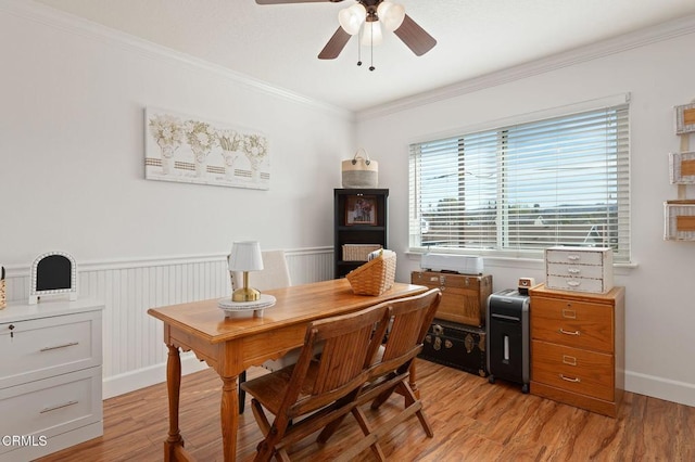 dining room with crown molding, ceiling fan, and light wood-type flooring