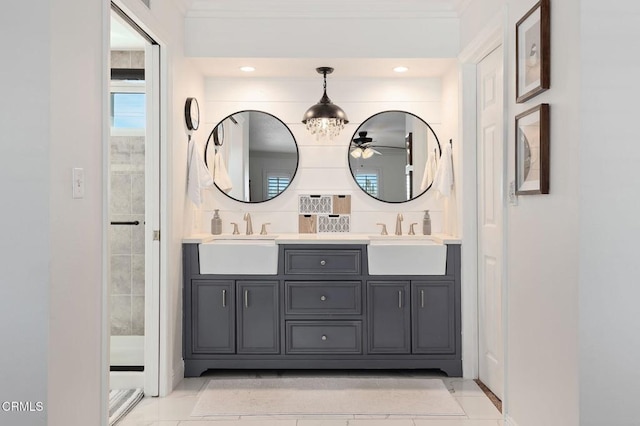 bathroom with vanity, a notable chandelier, ornamental molding, and walk in shower