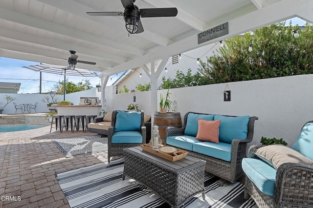 view of patio with ceiling fan, exterior bar, and an outdoor hangout area