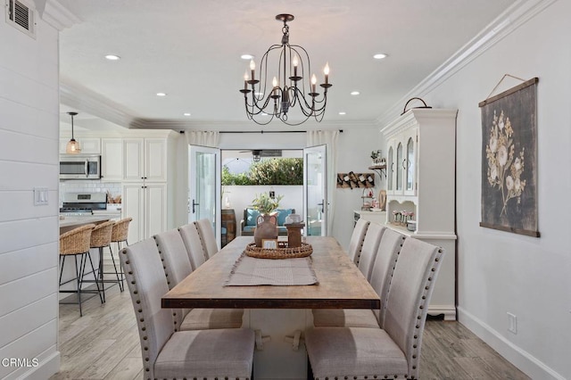 dining area featuring ornamental molding and light wood-type flooring