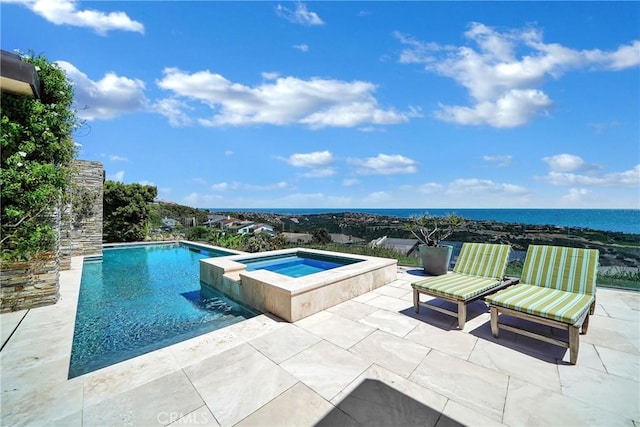 view of swimming pool featuring a patio area, an in ground hot tub, and a water view