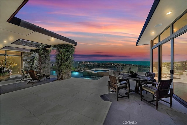 view of patio terrace at dusk