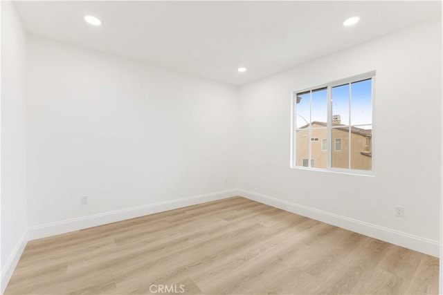 unfurnished room featuring light hardwood / wood-style floors