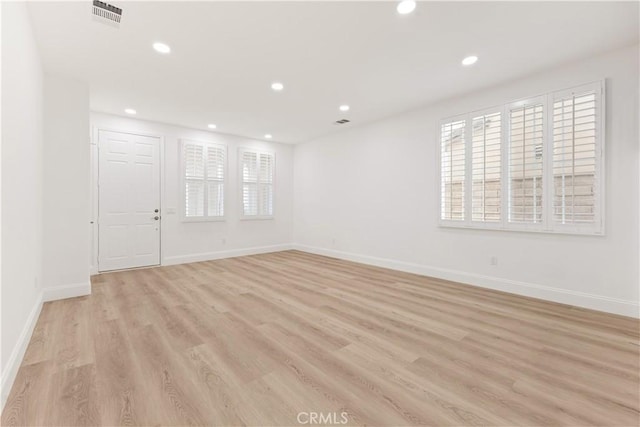 spare room with light wood-type flooring