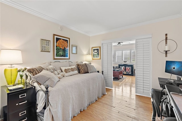 bedroom with light hardwood / wood-style flooring and ornamental molding