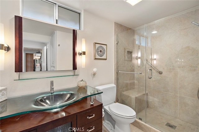 bathroom with walk in shower, vanity, and toilet