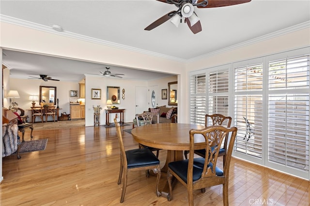 dining area with crown molding, a wealth of natural light, ceiling fan, and light hardwood / wood-style floors