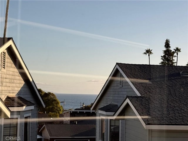 view of property exterior with a water view