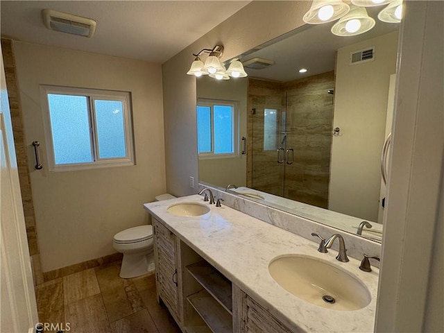 full bath with toilet, a stall shower, visible vents, and a sink