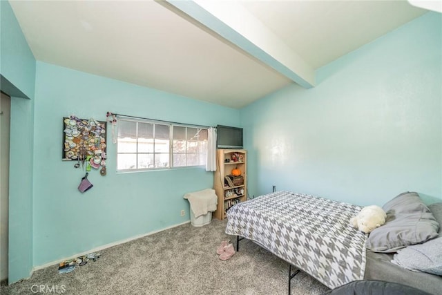 carpeted bedroom with beamed ceiling