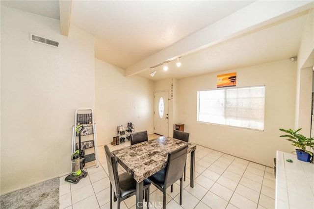 tiled dining space with beam ceiling