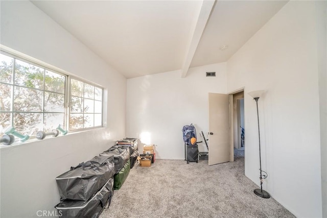 bedroom with light carpet and vaulted ceiling with beams