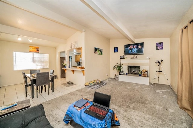 living room with lofted ceiling with beams and light tile patterned flooring