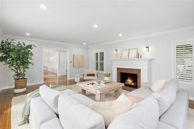 living room featuring hardwood / wood-style flooring, ornamental molding, and a fireplace