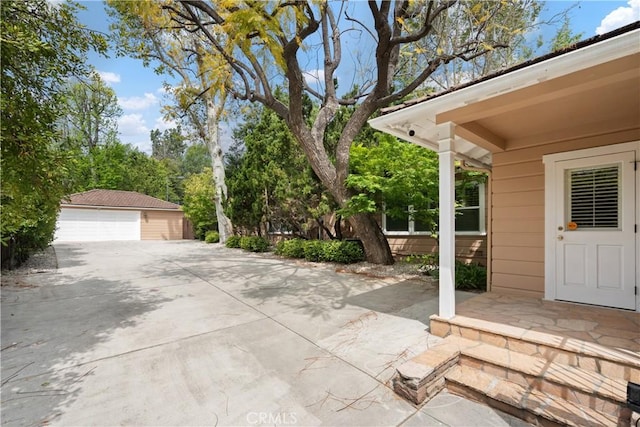 view of patio with a garage and an outdoor structure