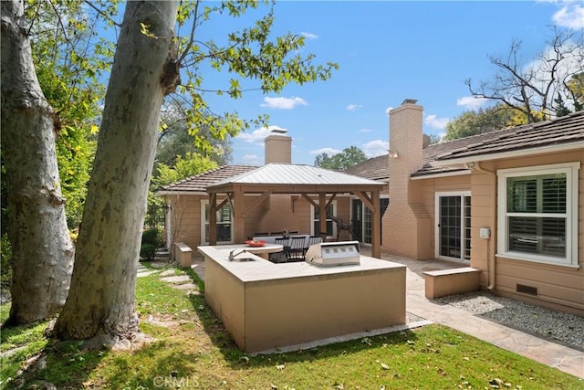 back of house featuring a gazebo, a yard, outdoor lounge area, and a patio