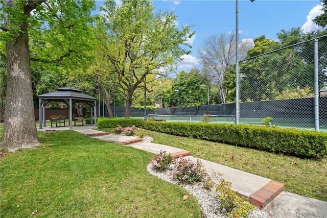 view of yard featuring a gazebo and tennis court