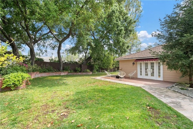 view of yard featuring a patio and french doors