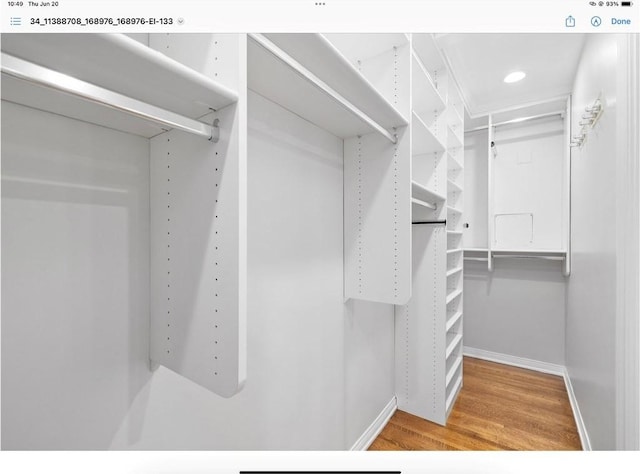 spacious closet featuring hardwood / wood-style flooring