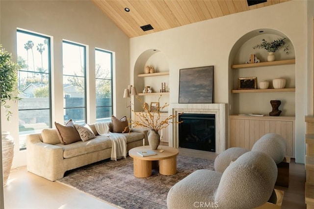 living room with high vaulted ceiling, built in features, wood ceiling, and a fireplace