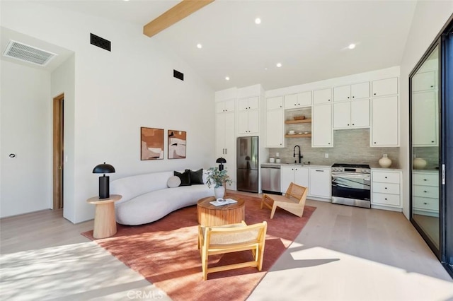 living room with beamed ceiling, sink, high vaulted ceiling, and light hardwood / wood-style flooring