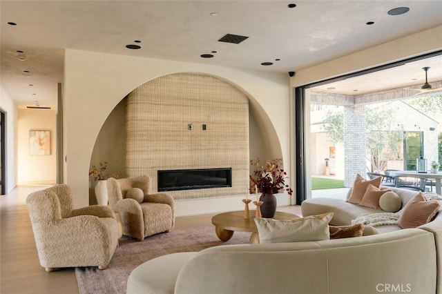 living area featuring a tiled fireplace and wood finished floors