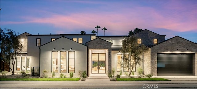 19845 Santa Rita St, Woodland Hills, CA 91364 - view of front of property with stucco siding, concrete driveway, stone siding, and a garage