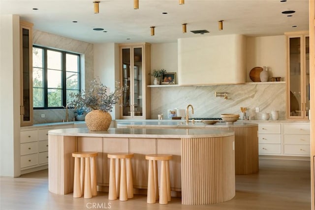 19845 Santa Rita St, Woodland Hills, CA 91364 - interior space featuring backsplash, light wood-style floors, and a sink