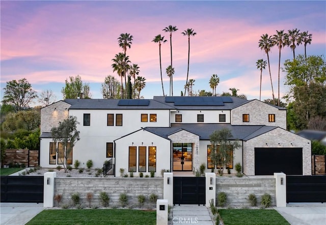 modern farmhouse with a fenced front yard and a gate