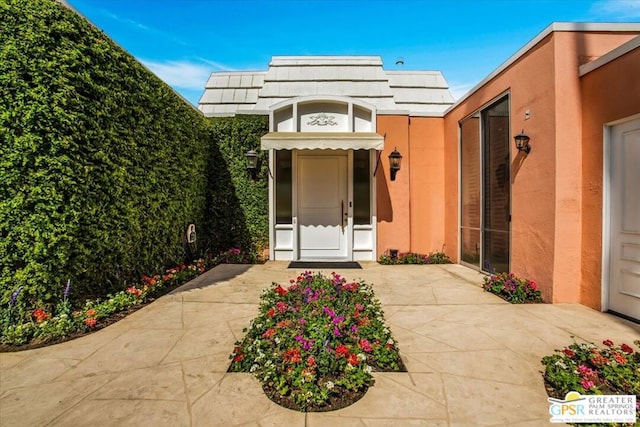 property entrance with a patio