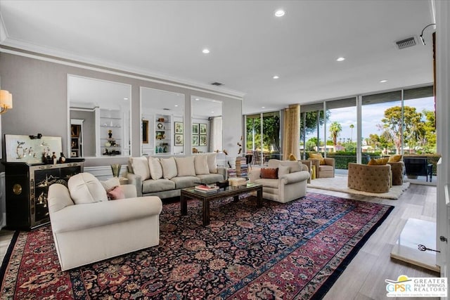 living room featuring expansive windows, ornamental molding, and light wood-type flooring