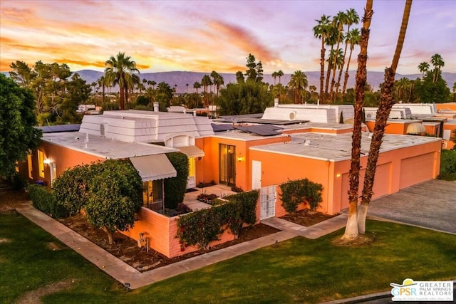 exterior space featuring a mountain view and a yard