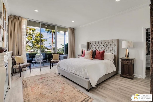 bedroom with floor to ceiling windows, ornamental molding, a spacious closet, access to outside, and light wood-type flooring