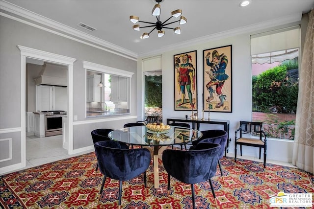 dining space with ornamental molding, a chandelier, and sink