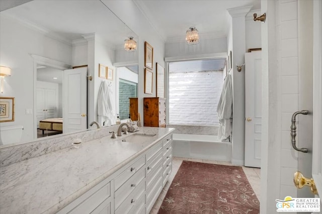 bathroom featuring a bathing tub, vanity, crown molding, tile patterned floors, and an inviting chandelier