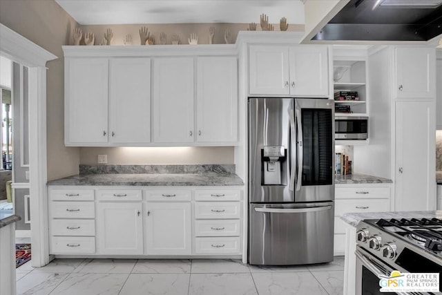 kitchen featuring white cabinetry, extractor fan, light stone counters, and appliances with stainless steel finishes