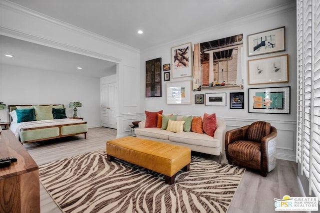 living room featuring ornamental molding and light hardwood / wood-style flooring