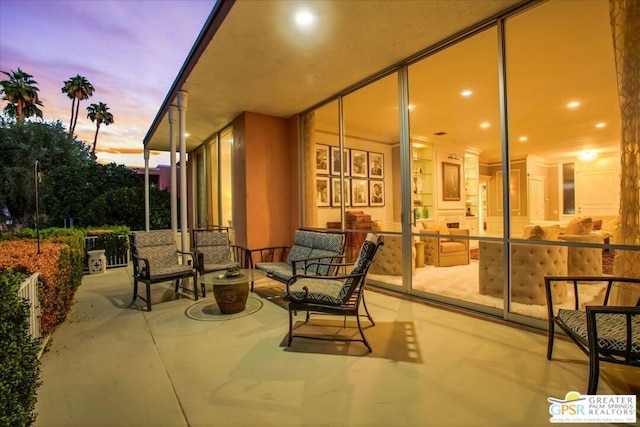 patio terrace at dusk featuring an outdoor hangout area