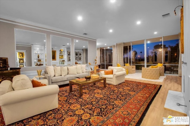 living room featuring ornamental molding and light wood-type flooring