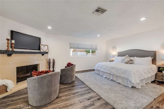 bedroom with dark wood-type flooring and a textured ceiling