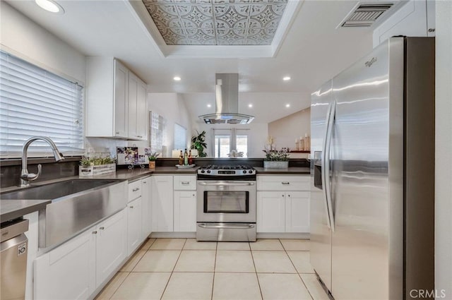 kitchen featuring stainless steel appliances, sink, island range hood, and white cabinets