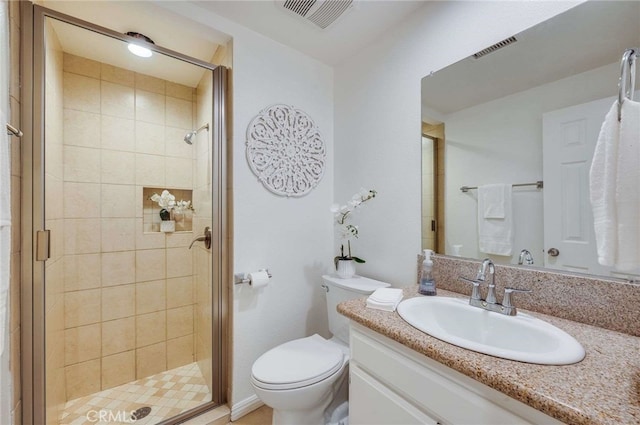 bathroom featuring vanity, walk in shower, and toilet