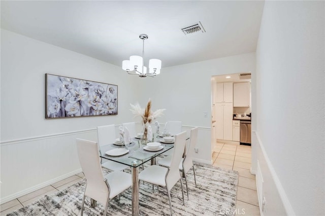 tiled dining room featuring a notable chandelier