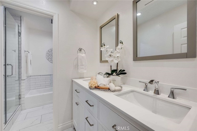 bathroom featuring vanity and separate shower and tub