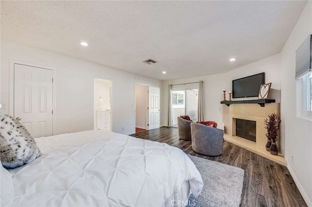 bedroom featuring wood-type flooring and a textured ceiling