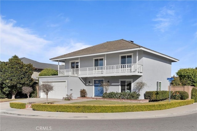 view of front of home featuring a balcony and a garage