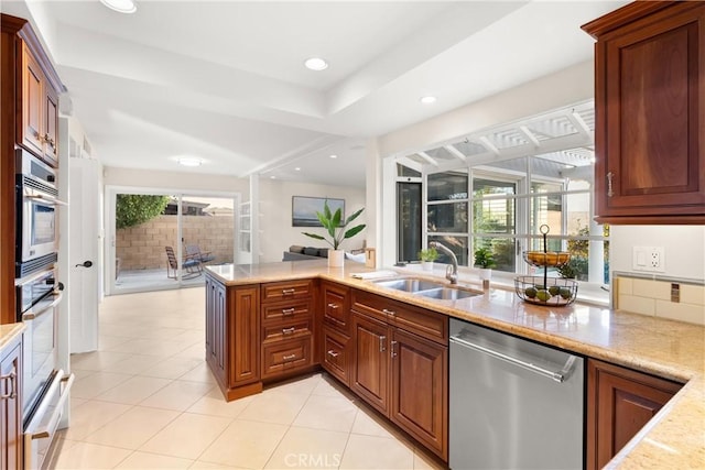 kitchen featuring a healthy amount of sunlight, appliances with stainless steel finishes, sink, and kitchen peninsula