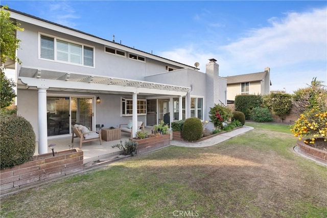 rear view of property featuring an outdoor living space, a pergola, a patio area, and a lawn