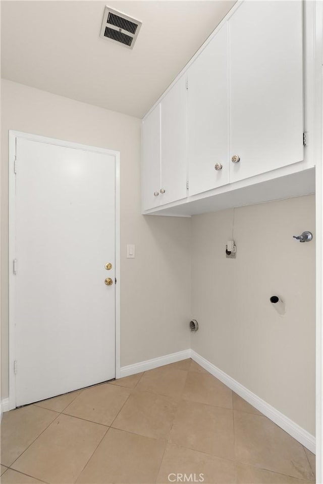 washroom with cabinets and light tile patterned flooring